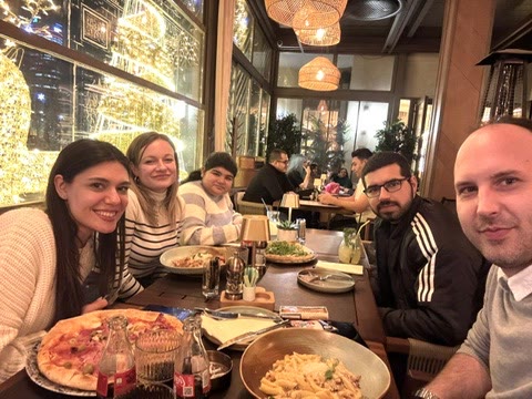 Tanishpreet and colleagues sharing a restaurant meal