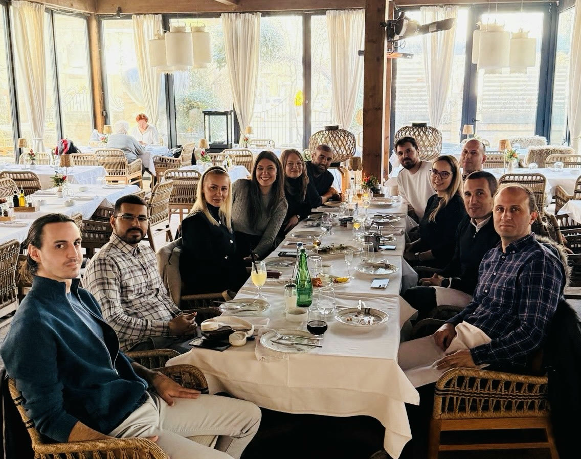 Tanishpreet and colleagues gathered around a restaurant table